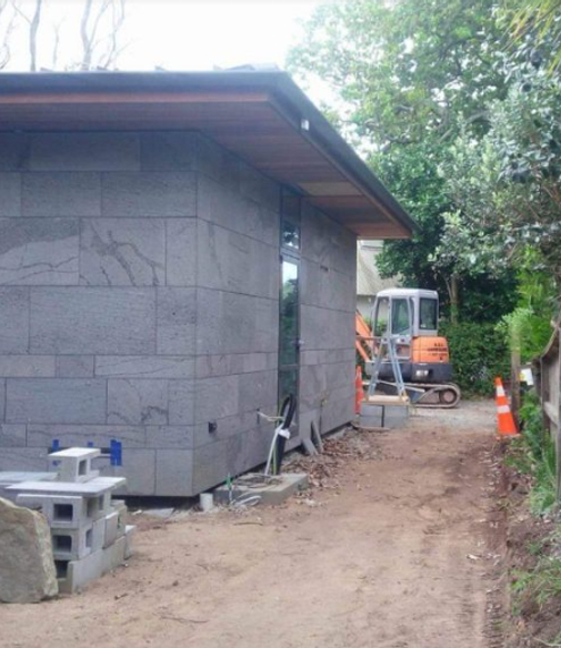 Newly built home with an excavated lawn ready for a driveway or new soil and grass