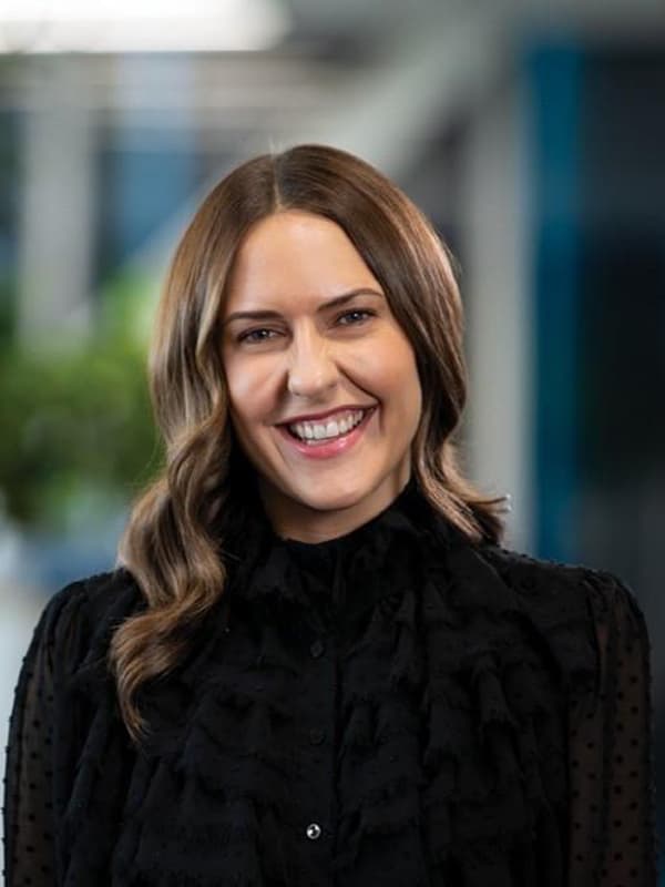 Sophie Logie with a big smile on her face and a cosy black top