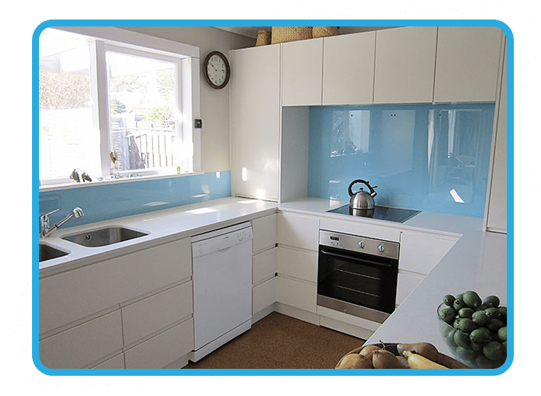 Off-white kitchen with custom fit baby blue splashback covering the wall by both the sink and the oven