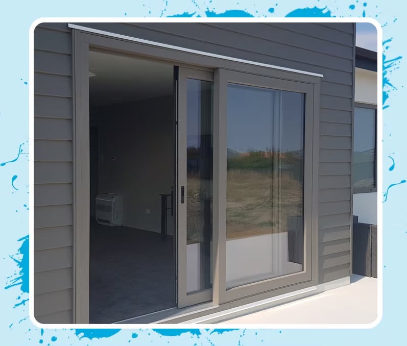 Grey weatherboard home with a large sliding door that has matching grey uPVC framing