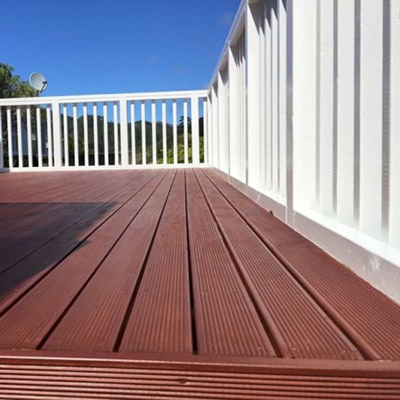 Newly finished timber deck with a contrasting white fence attached to a Wellington home