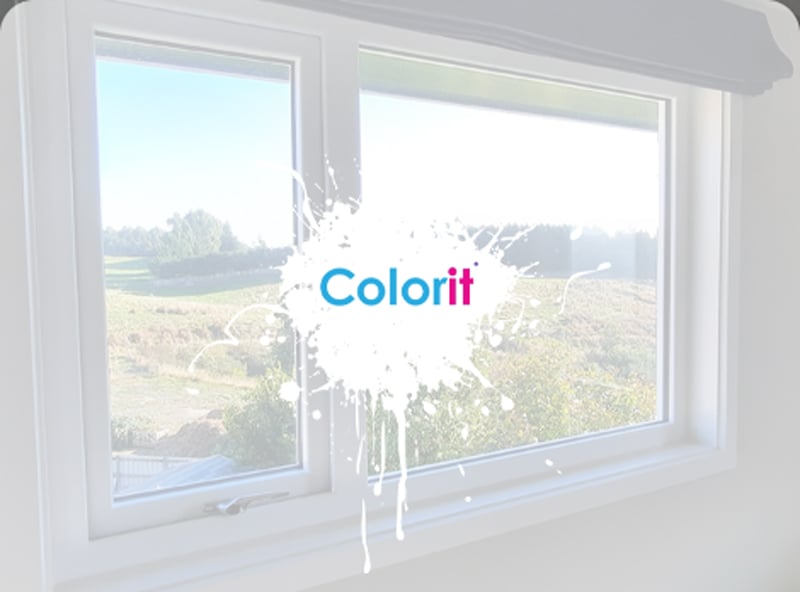 White uPVC window frame from the inside of a rural house that shows the outside view with lines of trees and large fields