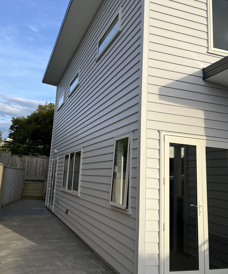 Sideview of a Wellington residential home with a new coat of off-white paint