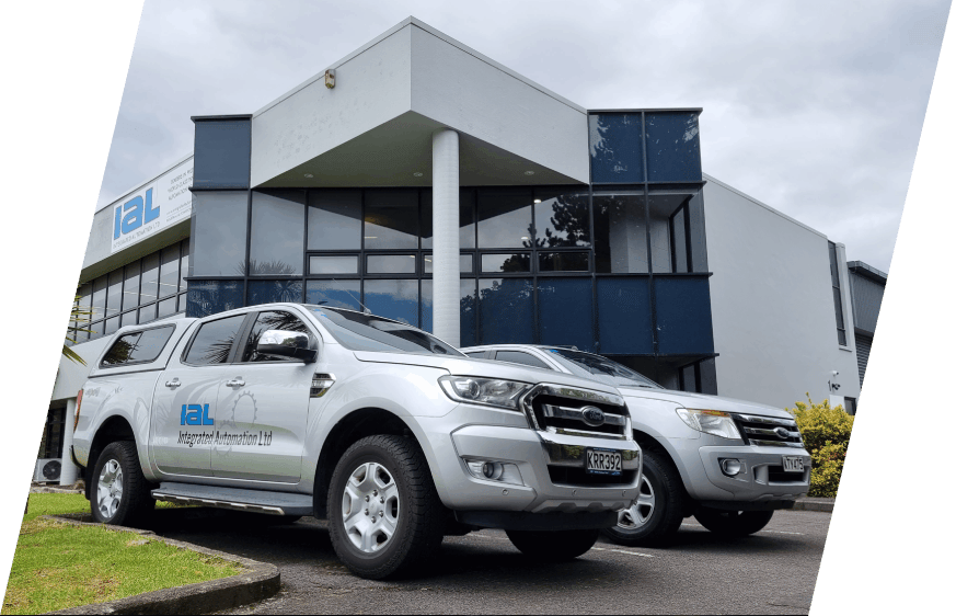 Integrated Automation Ltd branded work vehicles parked in front of the Integrated Automation headquarters building