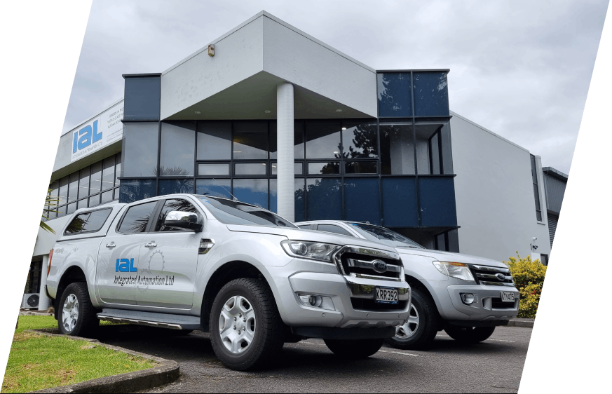 Integrated Automation Ltd branded work vehicles parked in front of the Integrated Automation headquarters building
